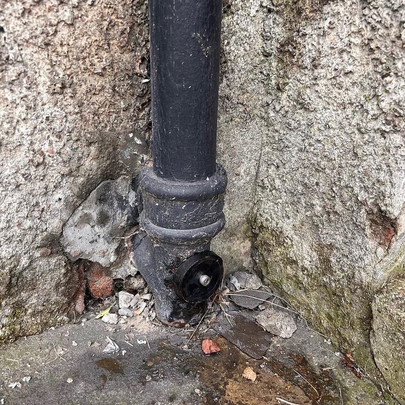 Access Point installed near the base of a cast iron pipe