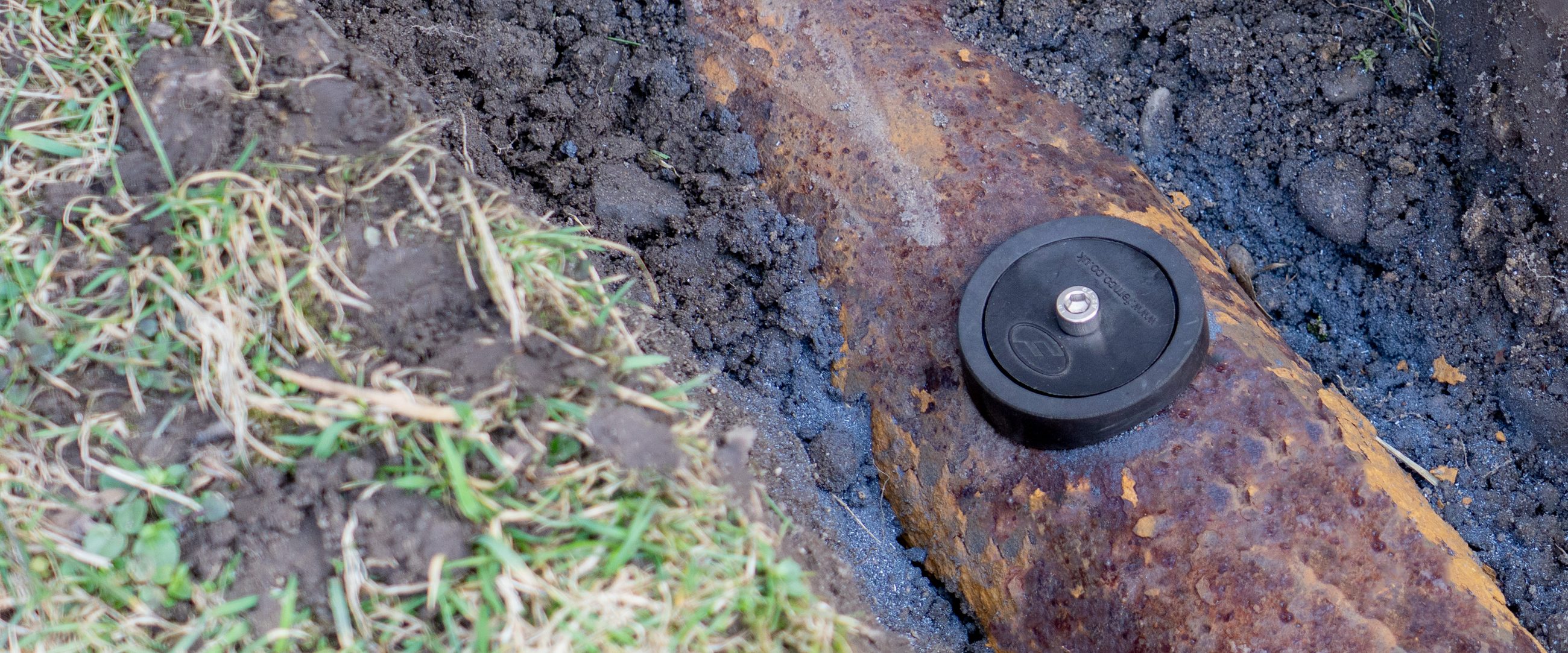 Fernco Access Point installed on a buried cast iron pipe