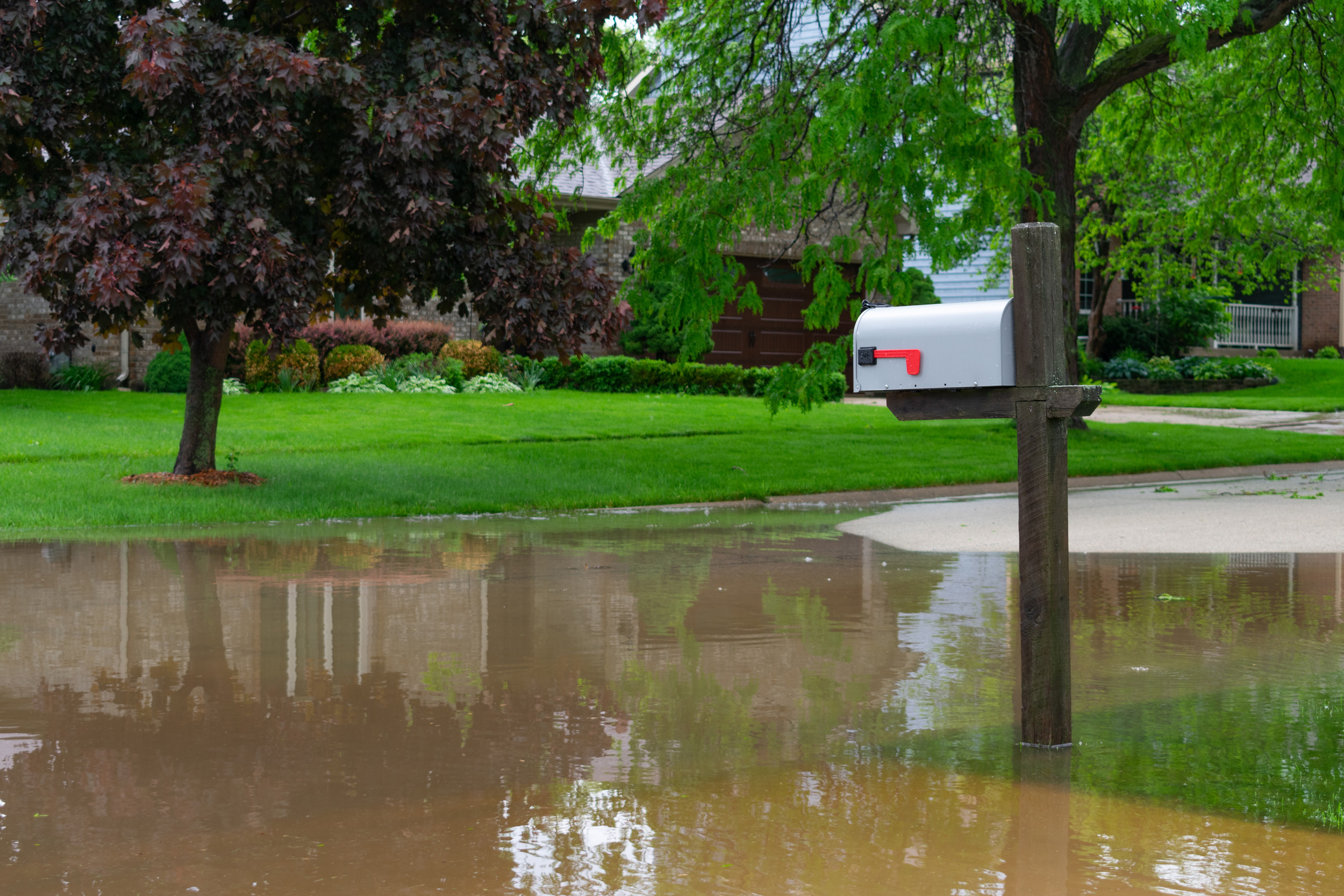 Mailbox beside a flooded residential street in a Midwestern community