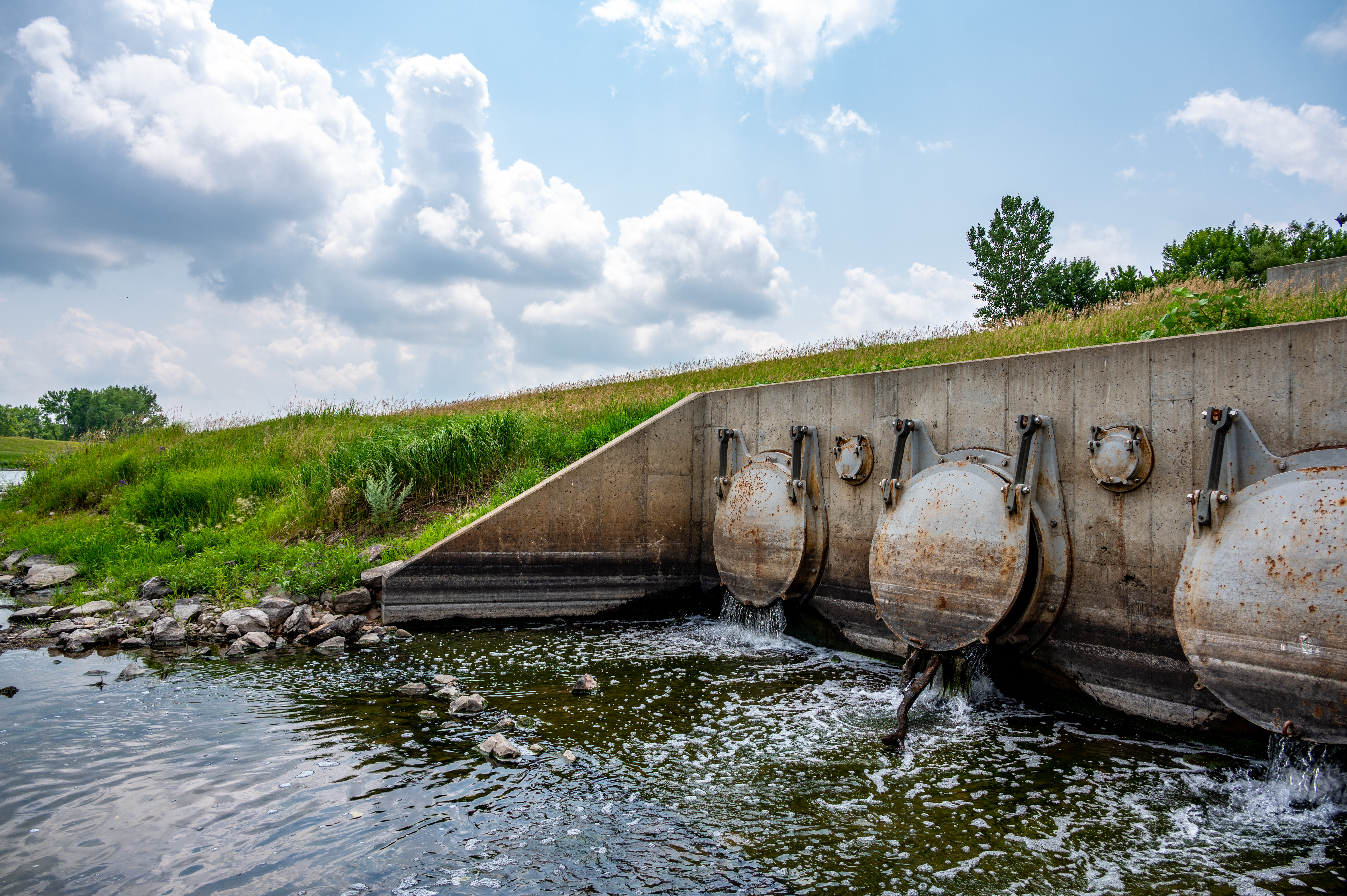 Bank of metal outfall flap gates discharging into a waterbody