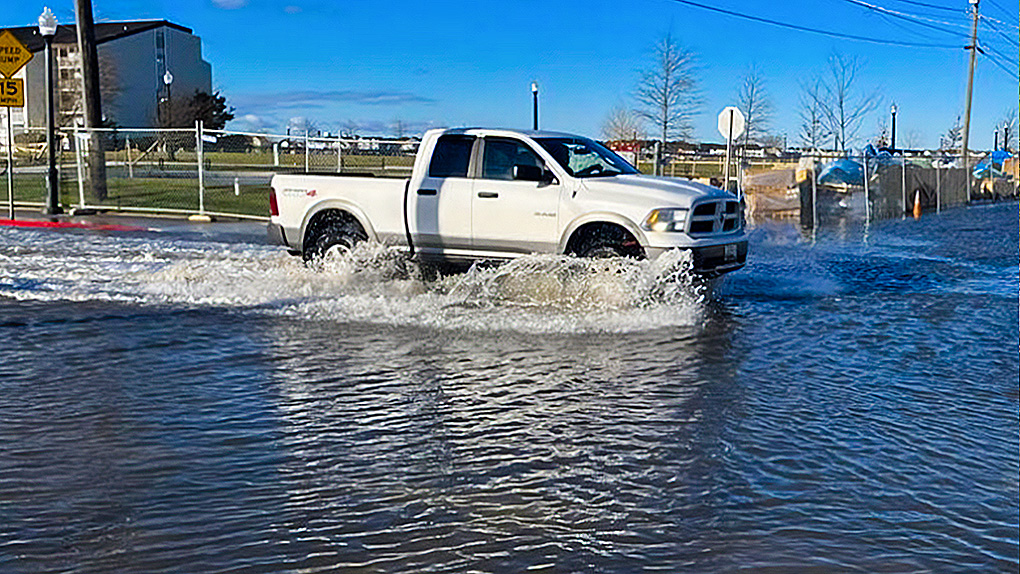 Pickup truck driving through a flooded street