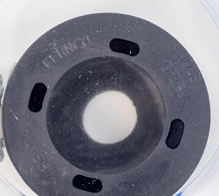 Top view of the Fernco Hose Grip showing the tapered center opening and four vents
