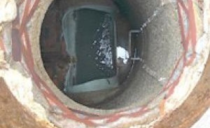 Looking down a corroded manhole in Hull, Massachusetts, before rehabilitation