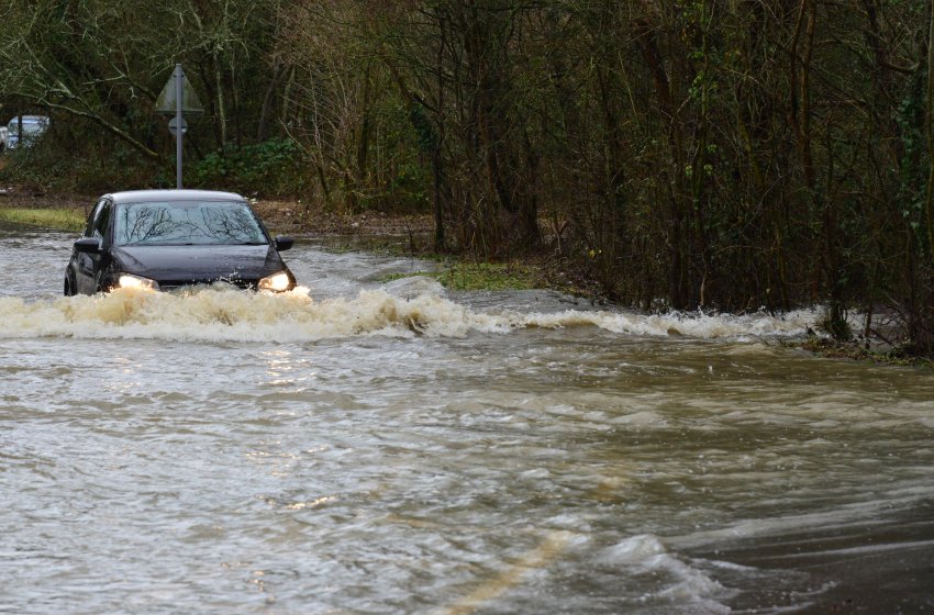 Car driving through flood waters