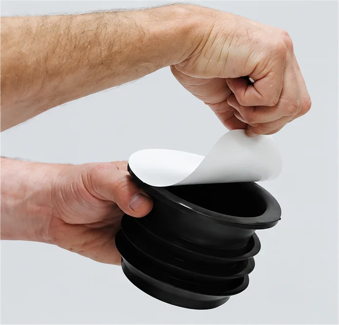 Peeling the protective liner off the Fernco wax-free seal