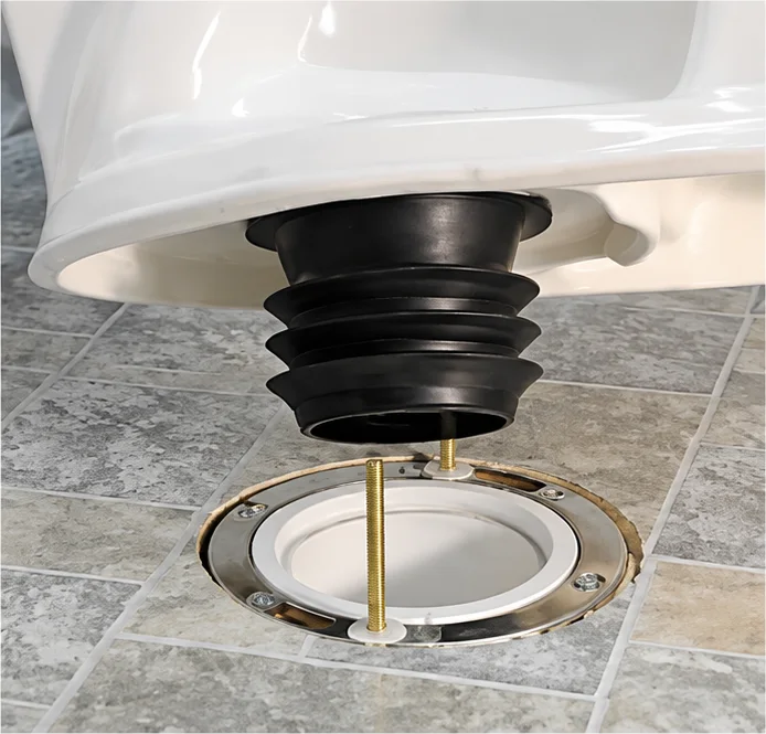 Lowering a toilet with the Fernco wax-free seal onto the floor flange