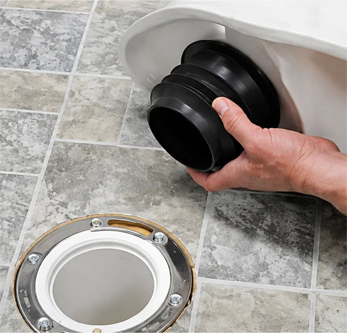 Pressing the Fernco wax-free seal onto the horn of a toilet